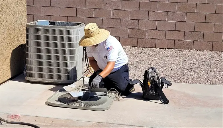Man repairing AC units