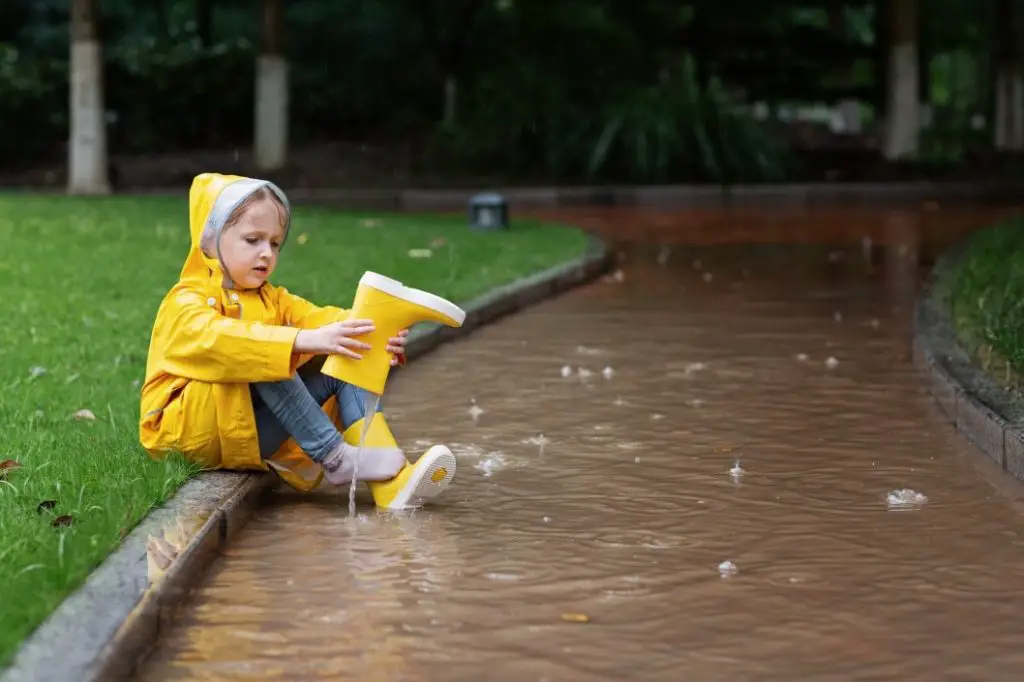 kid sitting in the rain