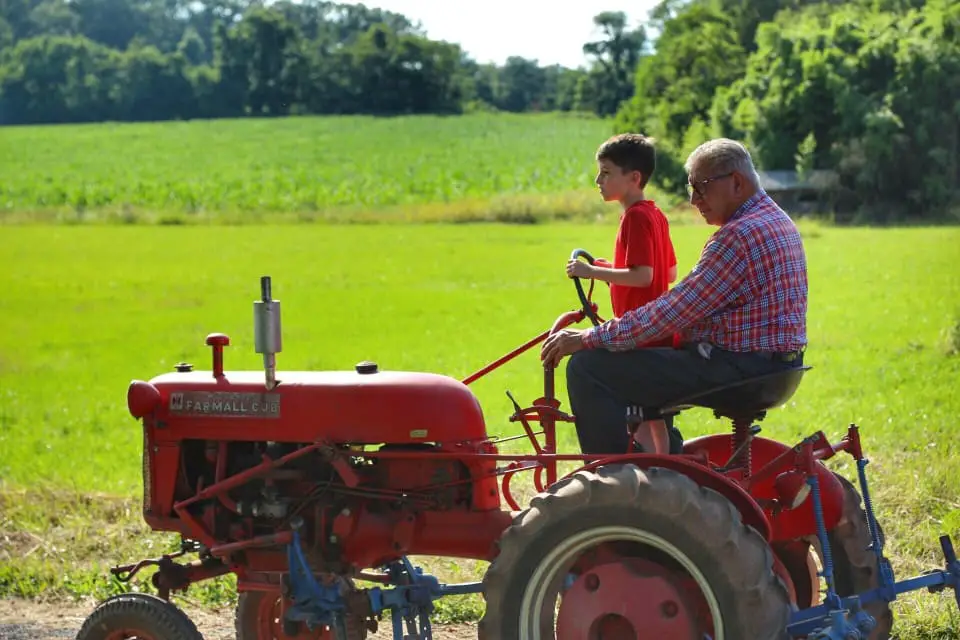 two people on a tractor