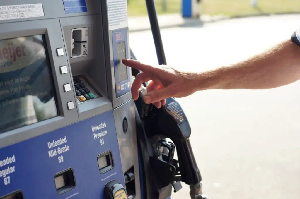 person choosing the type of gas at the gas station