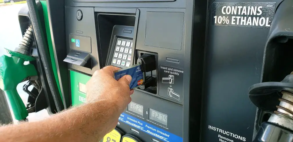 man using credit card at gas sation