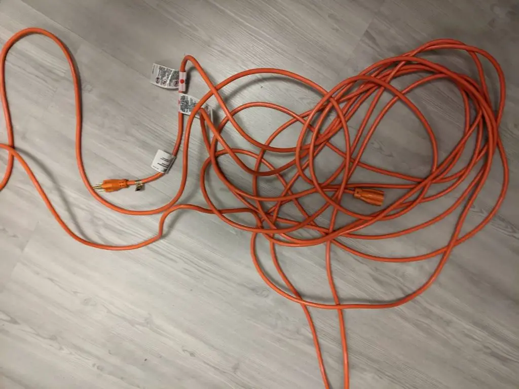 red extension cord on light background